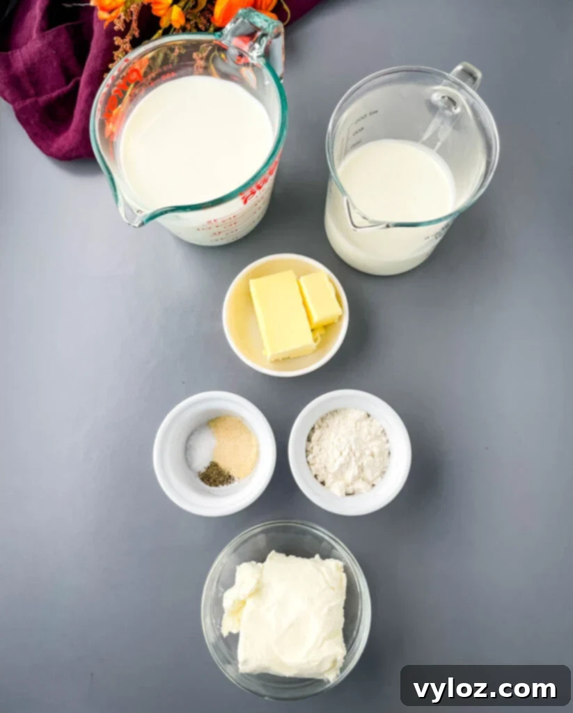 Gourmet Seafood Mac & Cheese 3 Separate bowls containing heavy cream, milk, butter, various spices, flour, and cream cheese, ready for mac and cheese preparation.