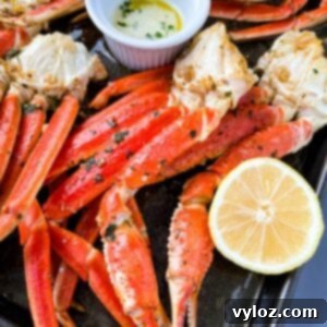 Decadent Garlic Butter Crab 7 baked crab legs on a pan with lemon garlic butter