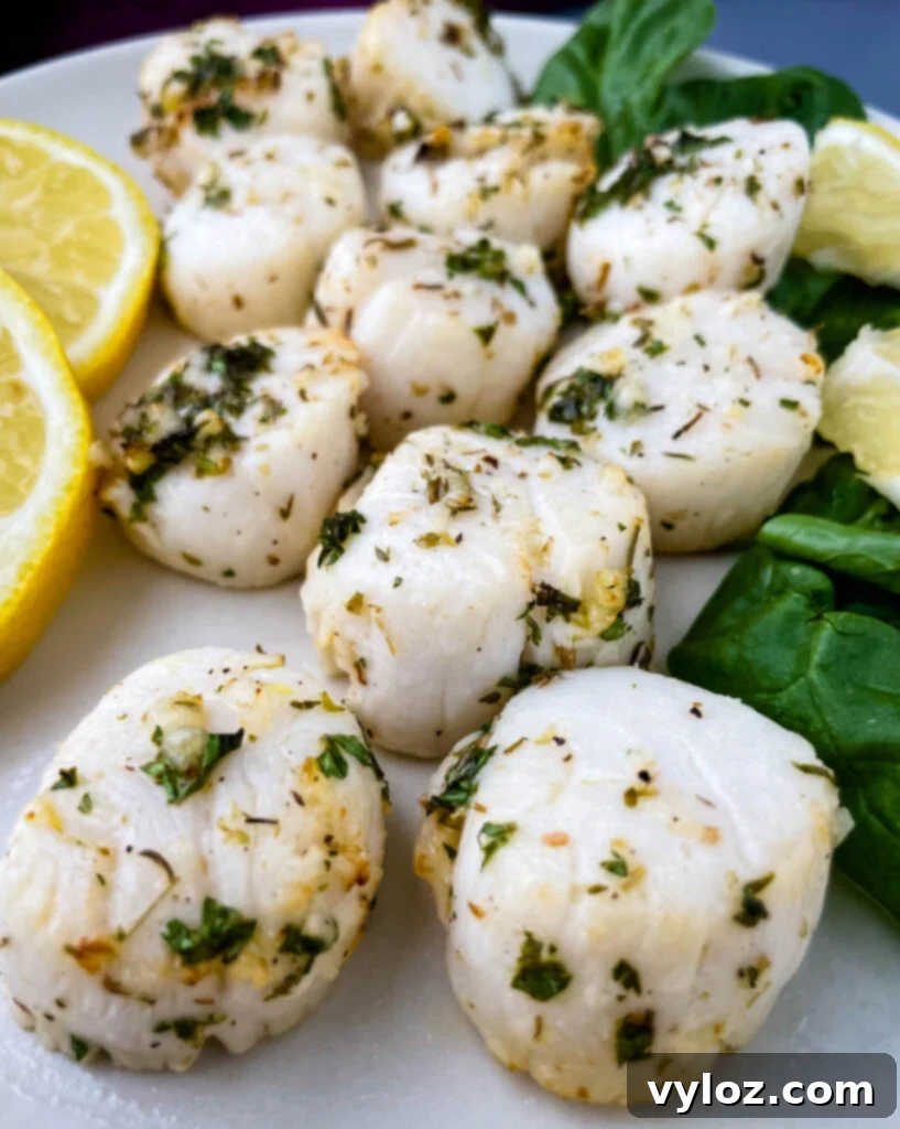 air fryer scallops on a plate with fresh lemon