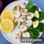 air fryer scallops on a plate with fresh lemon