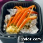 Easy Air Fryer Crab Legs 10 crab legs in an air fryer with foil
