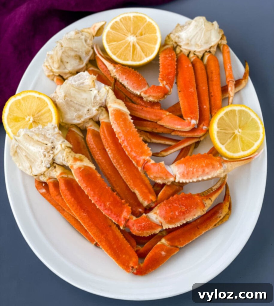 Instant Pot crab legs on a white plate with lemon