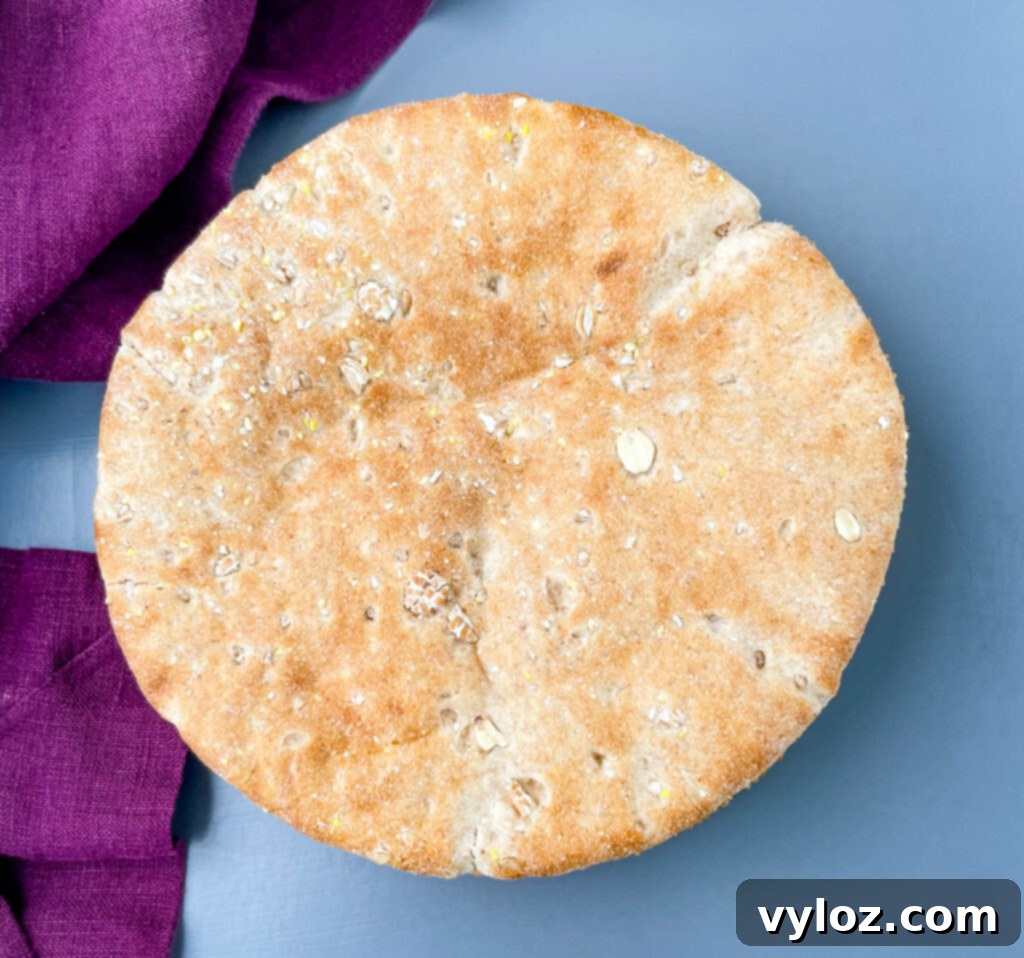 A stack of golden whole wheat pita bread rounds laid out on a clean, flat surface, awaiting transformation into delicious pizzas.
