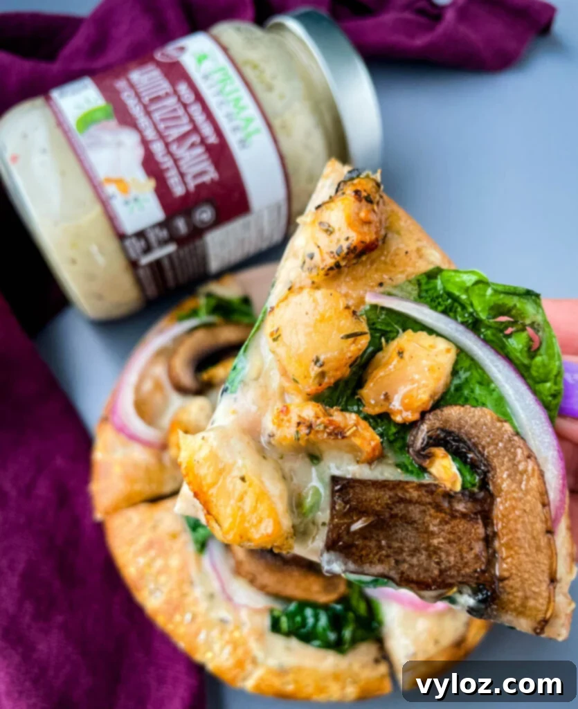 A close-up of a freshly baked pita bread pizza, steam gently rising, highlighting the perfectly melted cheese and cooked toppings, ready to be enjoyed.