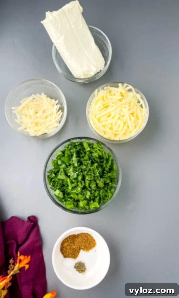 Bowls containing cream cheese, grated Parmesan cheese, shredded mozzarella, fresh spinach, and Italian seasoning, highlighting the filling components.