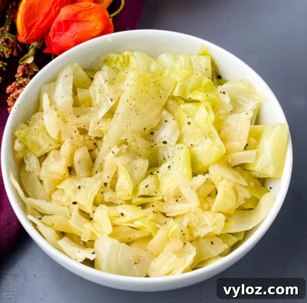 southern soul food cabbage in a white bowl sprinkled with pepper