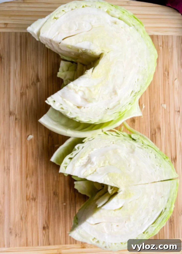fresh cabbage sliced into wedges on a cutting board