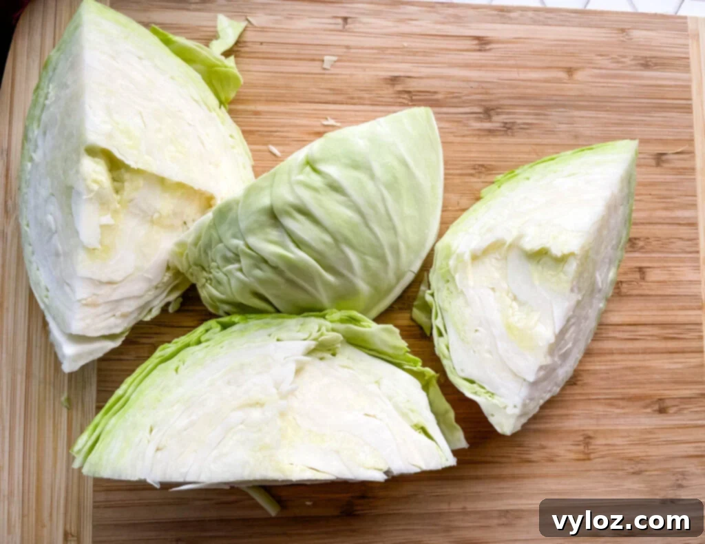 fresh cabbage sliced into wedges on a cutting board