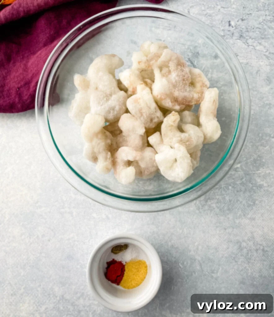 Crispy Air Fryer Frozen Shrimp 3 Frozen shrimp and spices in separate bowls