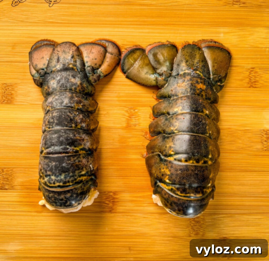 Perfect Air Fryer Lobster Tails 3 raw lobster tails on a cutting board