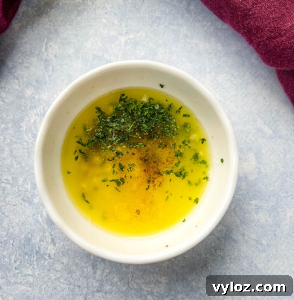 Perfect Air Fryer Lobster Tails 5 lemon garlic butter sauce in a white bowl