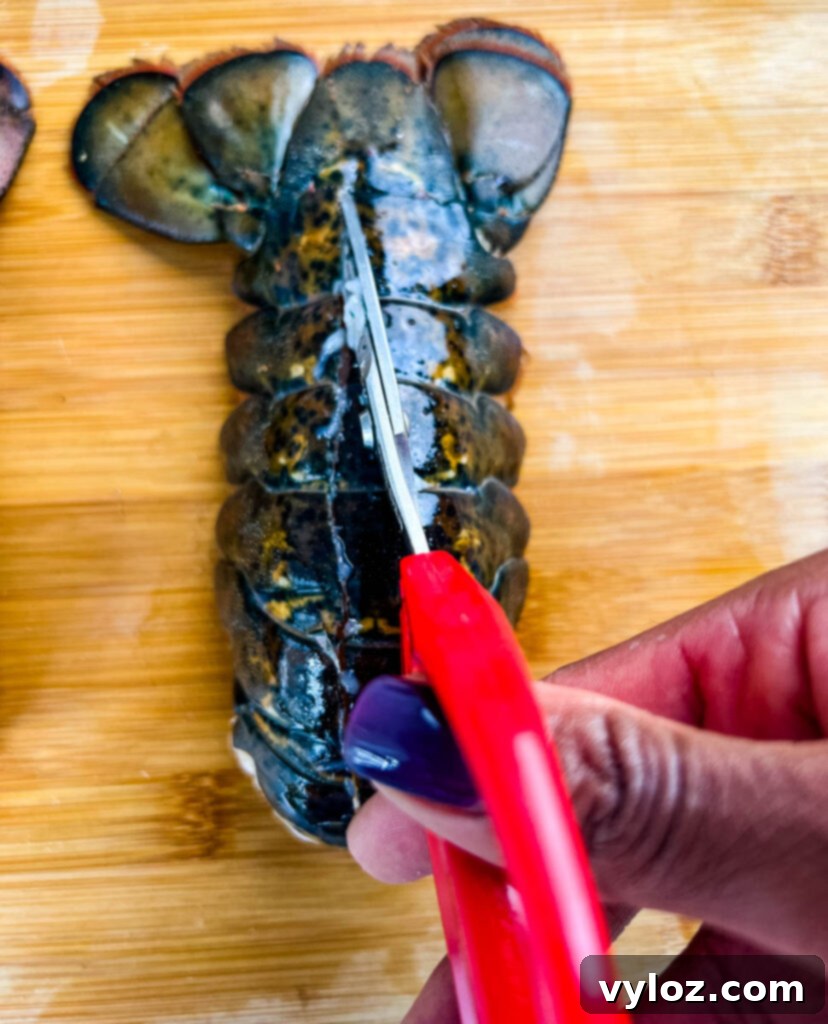 Perfect Air Fryer Lobster Tails 6 person slicing through lobster tail