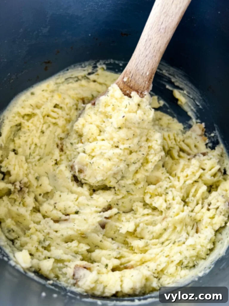 Ranch Mashed Potatoes 7 ranch mashed potatoes in a pot with a wooden spoon
