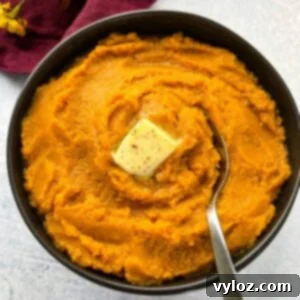 A bowl of creamy mashed sweet potatoes with butter and brown sugar
