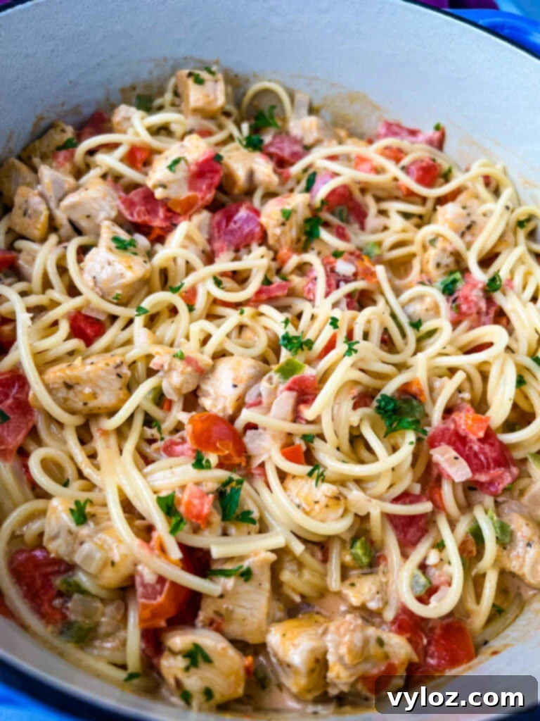 A close-up of creamy Southern chicken spaghetti, showing the rich texture and ingredients.