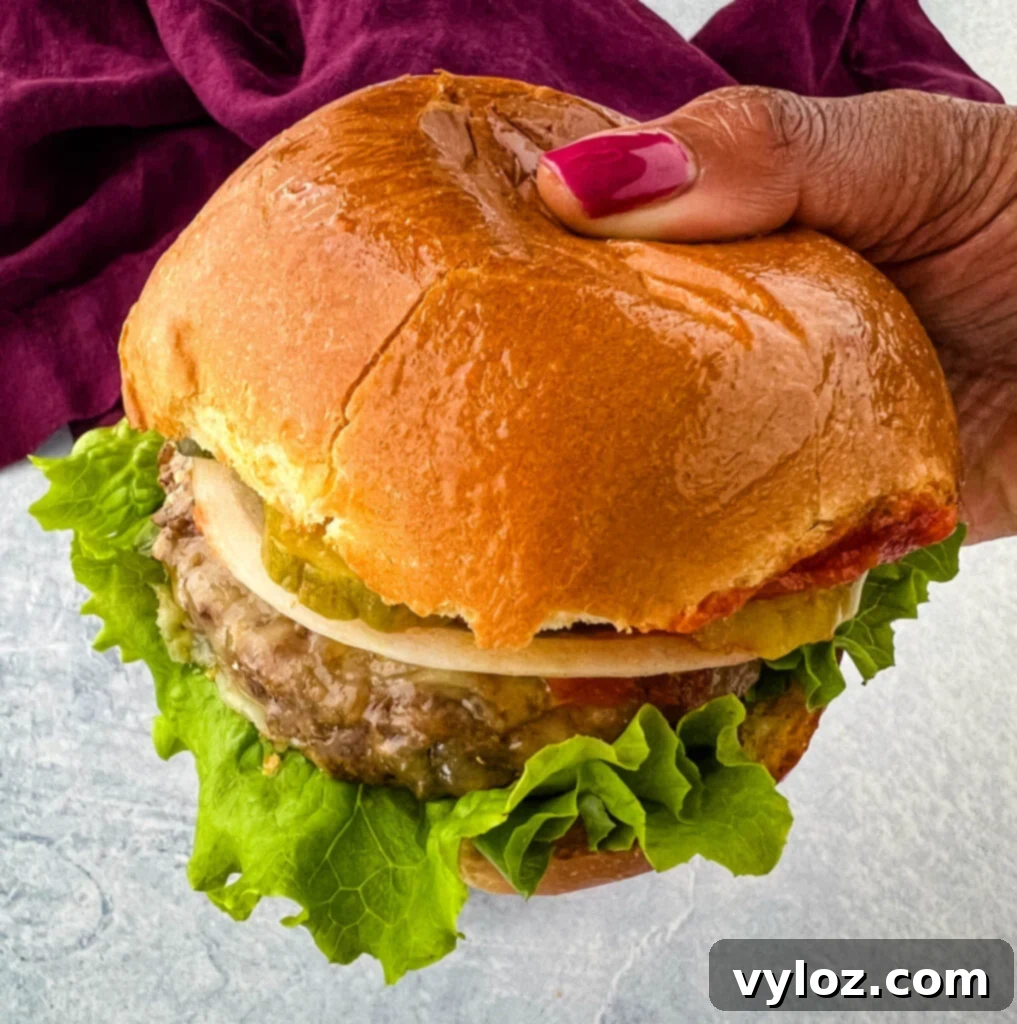 Crispy Air Fryer Frozen Burgers: From Freezer to Plate 10 person holding air fryer cheeseburger