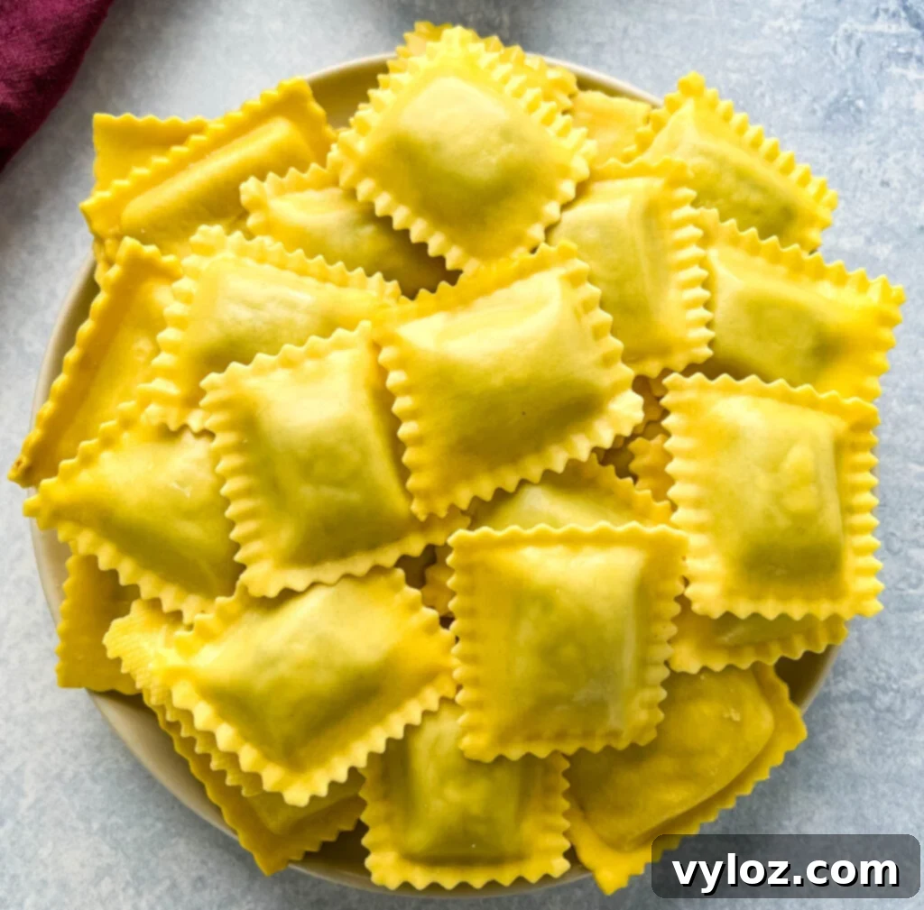 Uncooked, plain ravioli laid out on a plate, ready for preparation