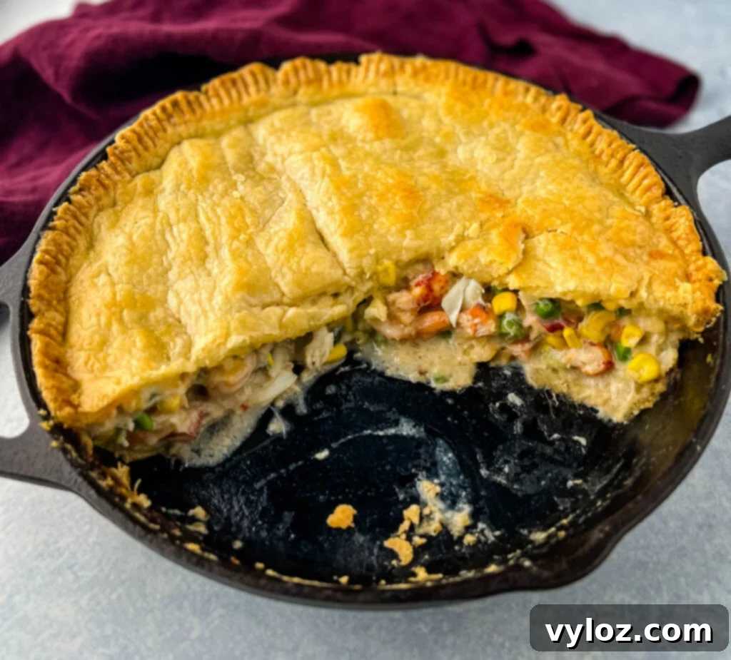 Freshly baked seafood pot pie in a cast iron skillet, with a golden-brown crust.