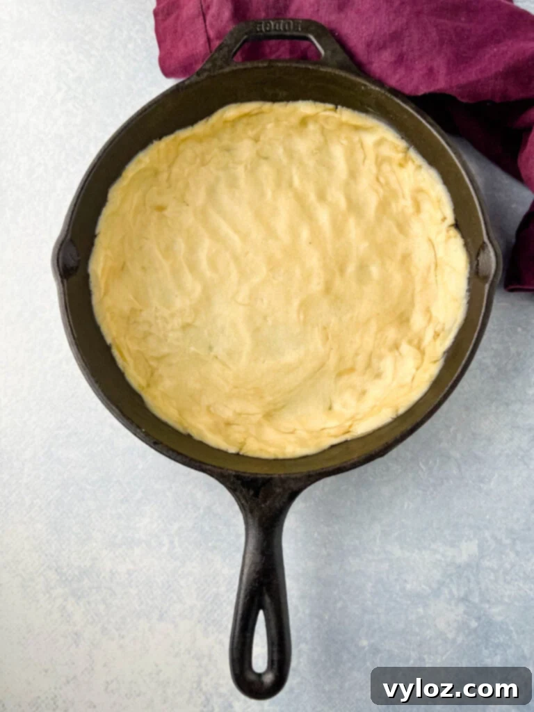 Unbaked pie crust carefully placed in the bottom of a cast iron skillet.