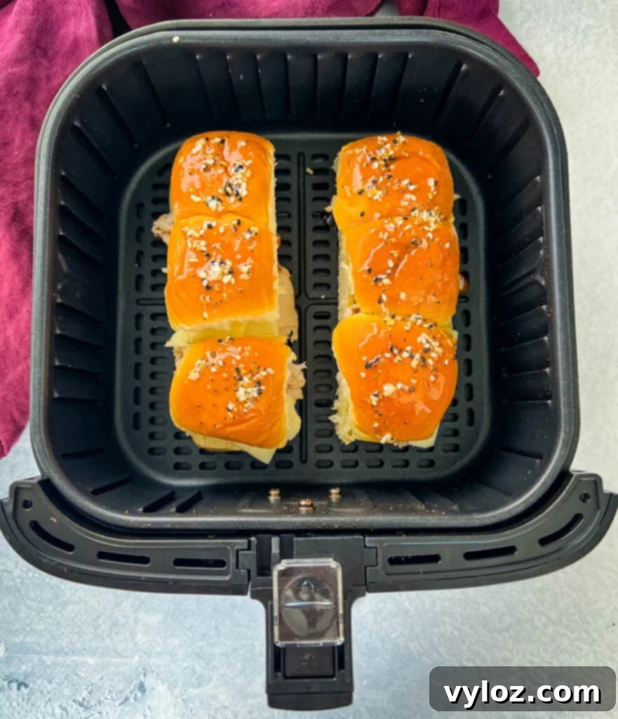 Cheesy Turkey Sliders 10 Freshly baked turkey cheese sliders cooling in an air fryer basket