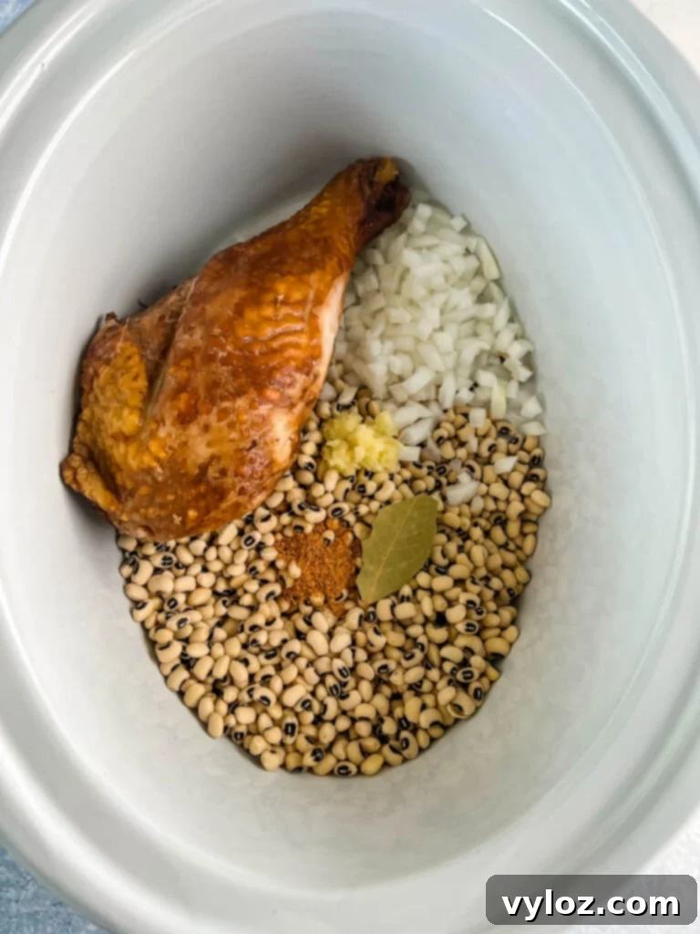 No-Soak Slow Cooker Smoked Turkey Black Eyed Peas 4 dried black eyed peas, onions, bay leaf, spices, and smoked turkey in slow cooker Crockpot