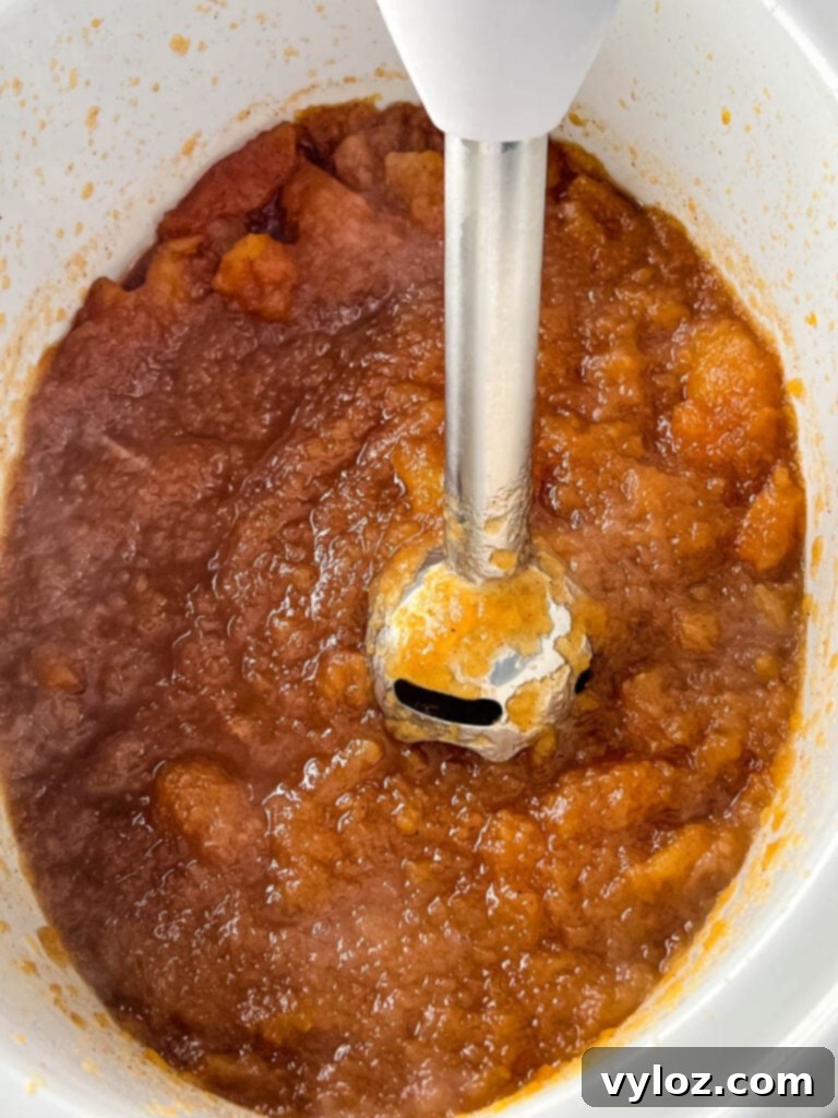 Wholesome Apple Butter 9 sugar free apple butter in a slow cooker with an immersion blender