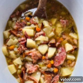 Hearty Slow Cooker Ham, Potato and Vegetable Soup 12 Slow cooker ham and potato soup in a Crockpot with vegetables, ready for serving.