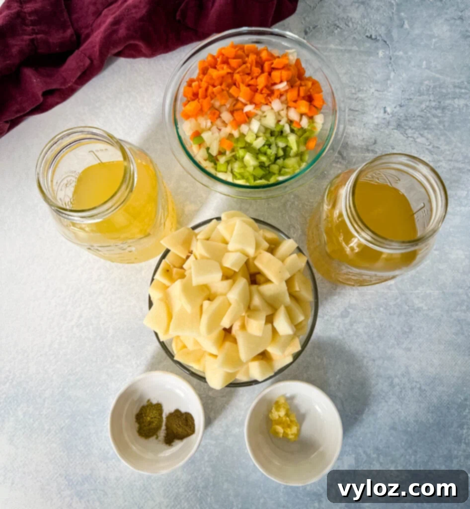 Hearty Slow Cooker Ham, Potato and Vegetable Soup 4 Bowls filled with diced white potatoes, chopped mirepoix vegetables, rich broth, and fragrant spices, ready for slow cooking.
