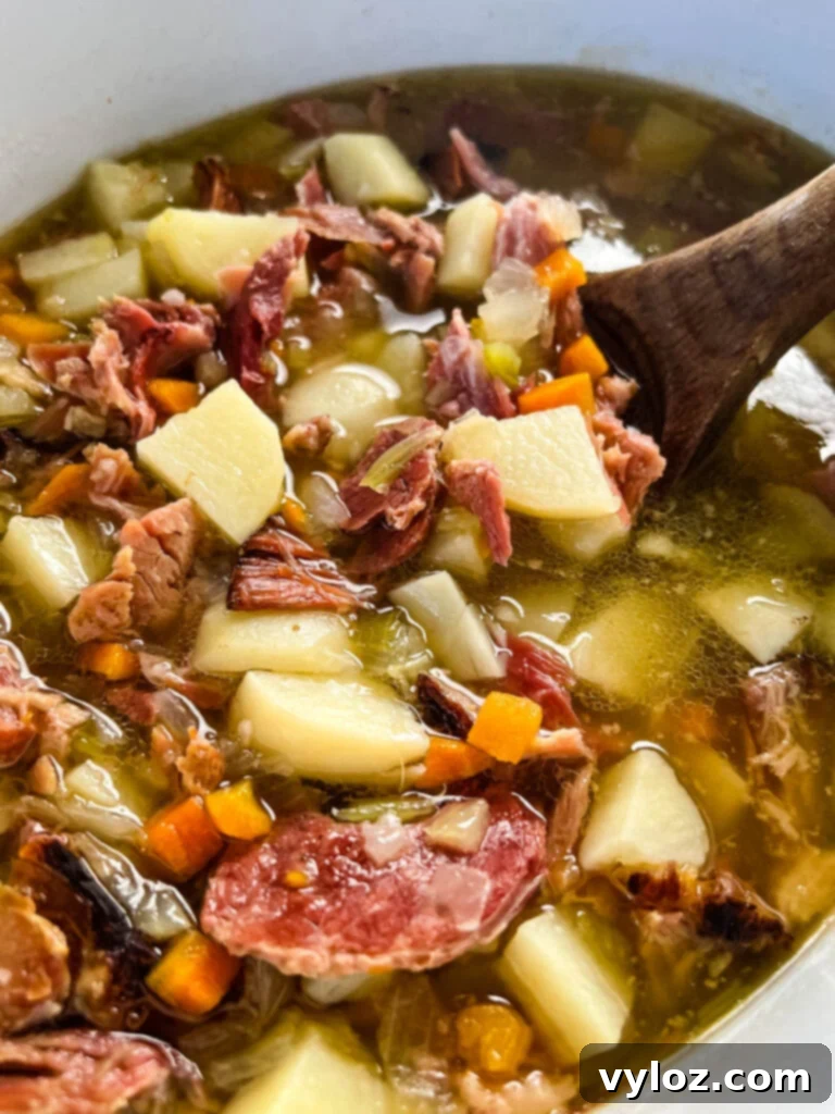 Hearty Slow Cooker Ham, Potato and Vegetable Soup 8 Multiple views of the finished slow cooker ham and potato soup, warm and ready to serve in a Crockpot, highlighting its rich texture and ingredients.