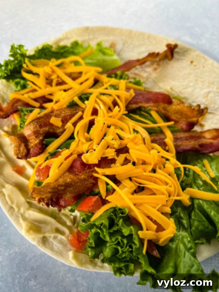 Quick BLT Wrap 5 blt wrap with bacon, lettuce, tomato, and mayo on a plate in a tortilla
