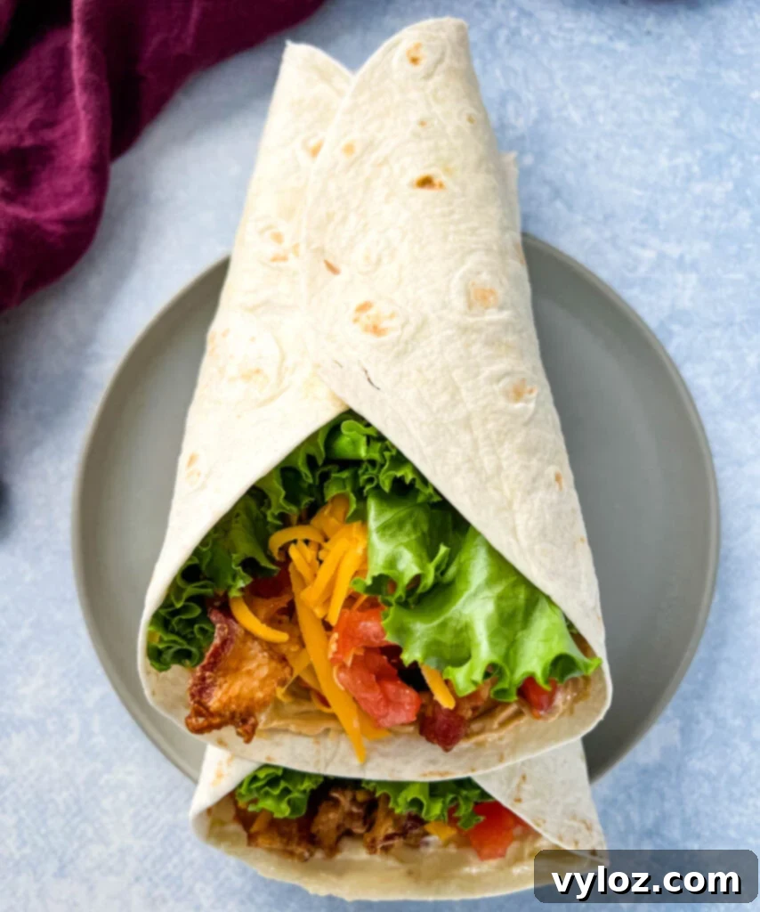 Quick BLT Wrap 6 blt wrap with bacon, lettuce, tomato, and mayo on a plate in a tortilla