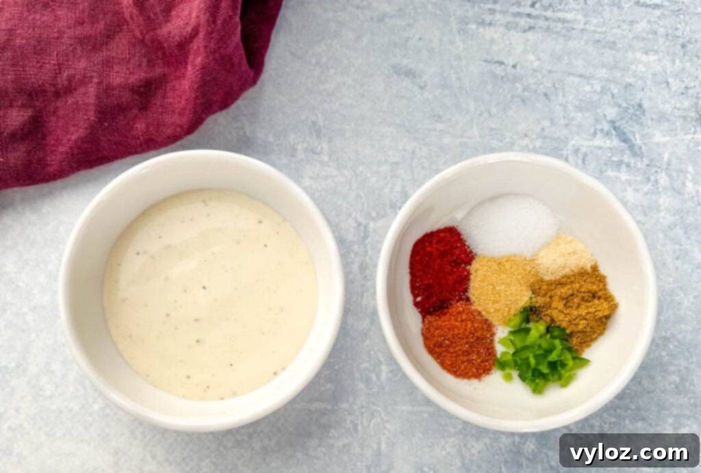 Ingredients for homemade Taco Bell creamy jalapeno sauce, including ranch dressing and various spices, laid out on a surface.