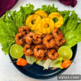 Effortless Caribbean Shrimp 14 jerk shrimp on lettuce with pineapples, limes, and fresh peppers