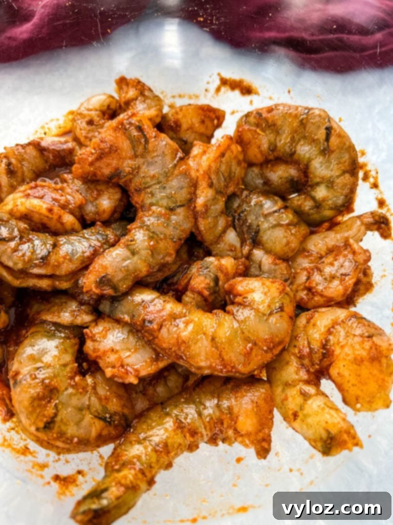 Effortless Caribbean Shrimp 9 raw jerk shrimp in glass bowl with jerk marinade