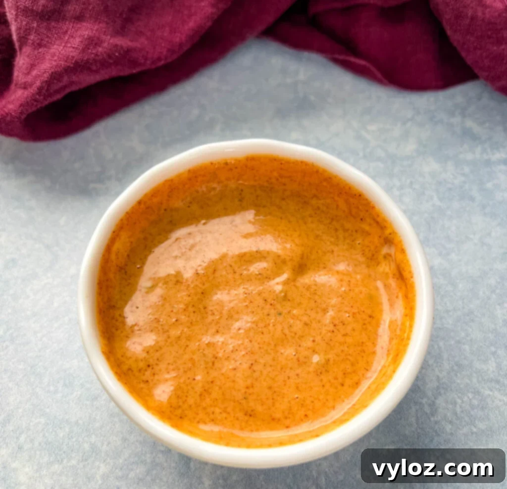 Taco Bell Zesty Jalapeno Cream 4 Taco Bell creamy jalapeno sauce in a serving bowl, with a spoon for dipping