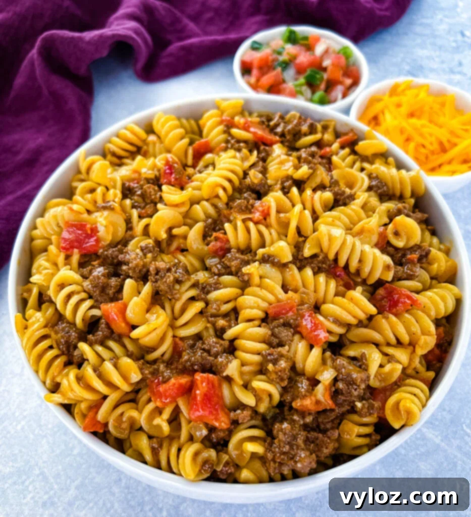 cheesy taco pasta in a white bowl