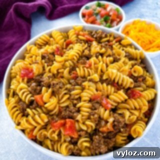 cheesy taco pasta in a white bowl