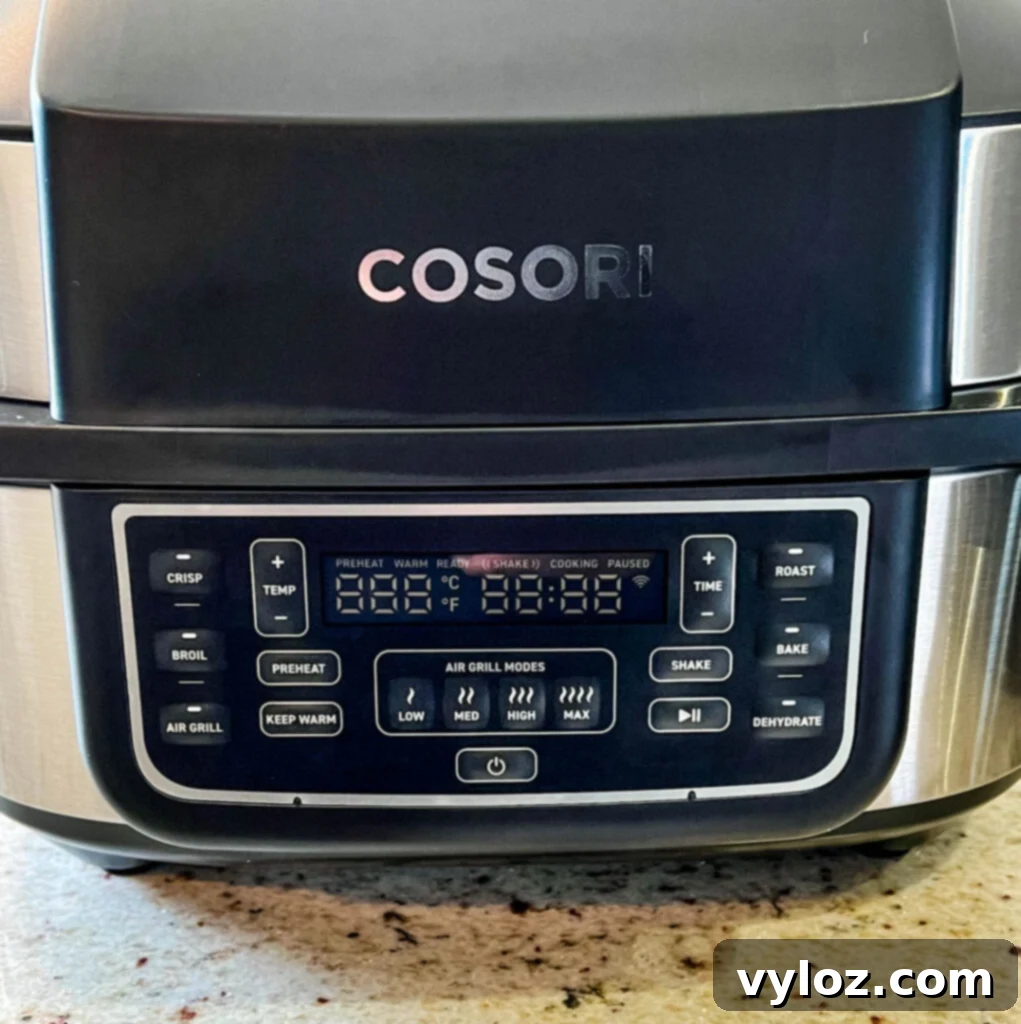 Cosori Aeroblaze Indoor Grill on a kitchen counter, showcasing its sleek design and compact footprint.