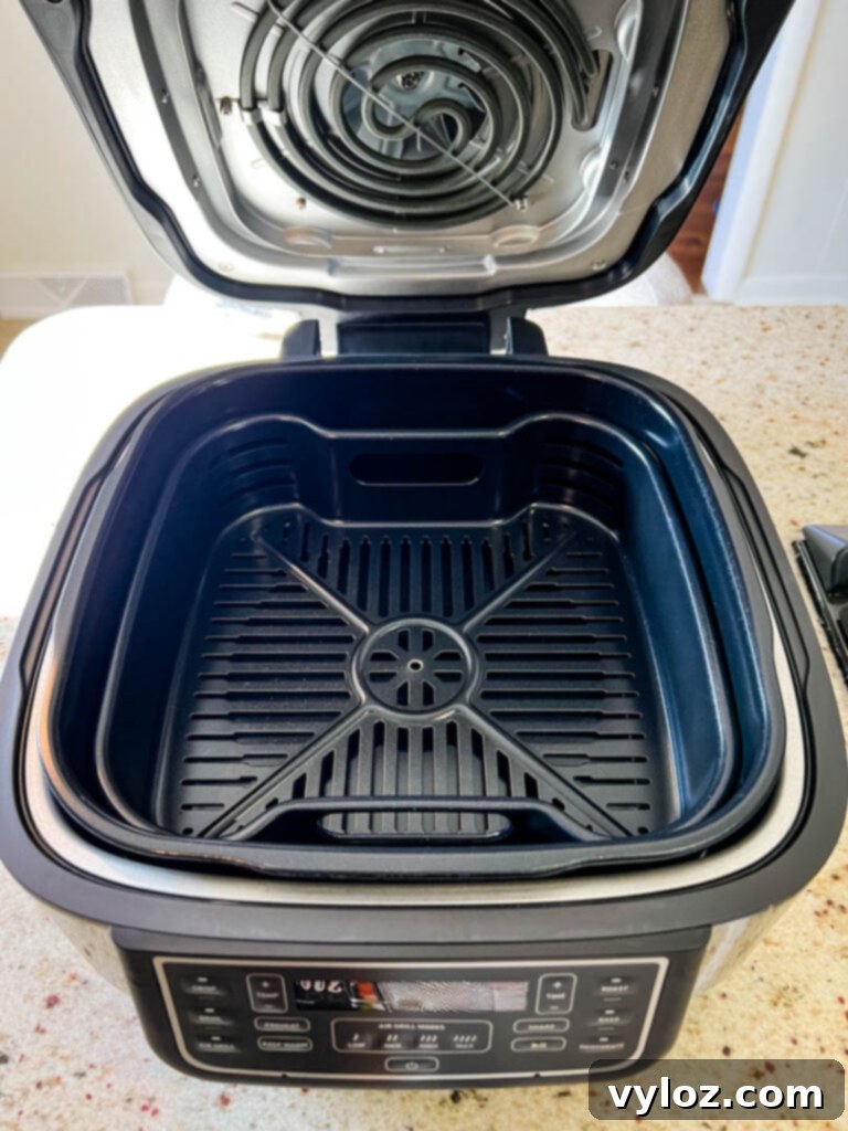 Cosori Aeroblaze Indoor Grill on a kitchen counter, showcasing its user-friendly control panel and sleek design.