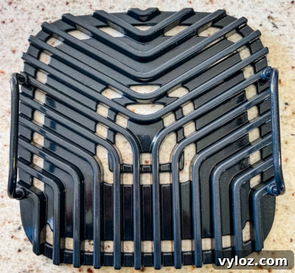 Close-up of the Cosori indoor grill plate, showing the distinct grill lines and non-stick surface.