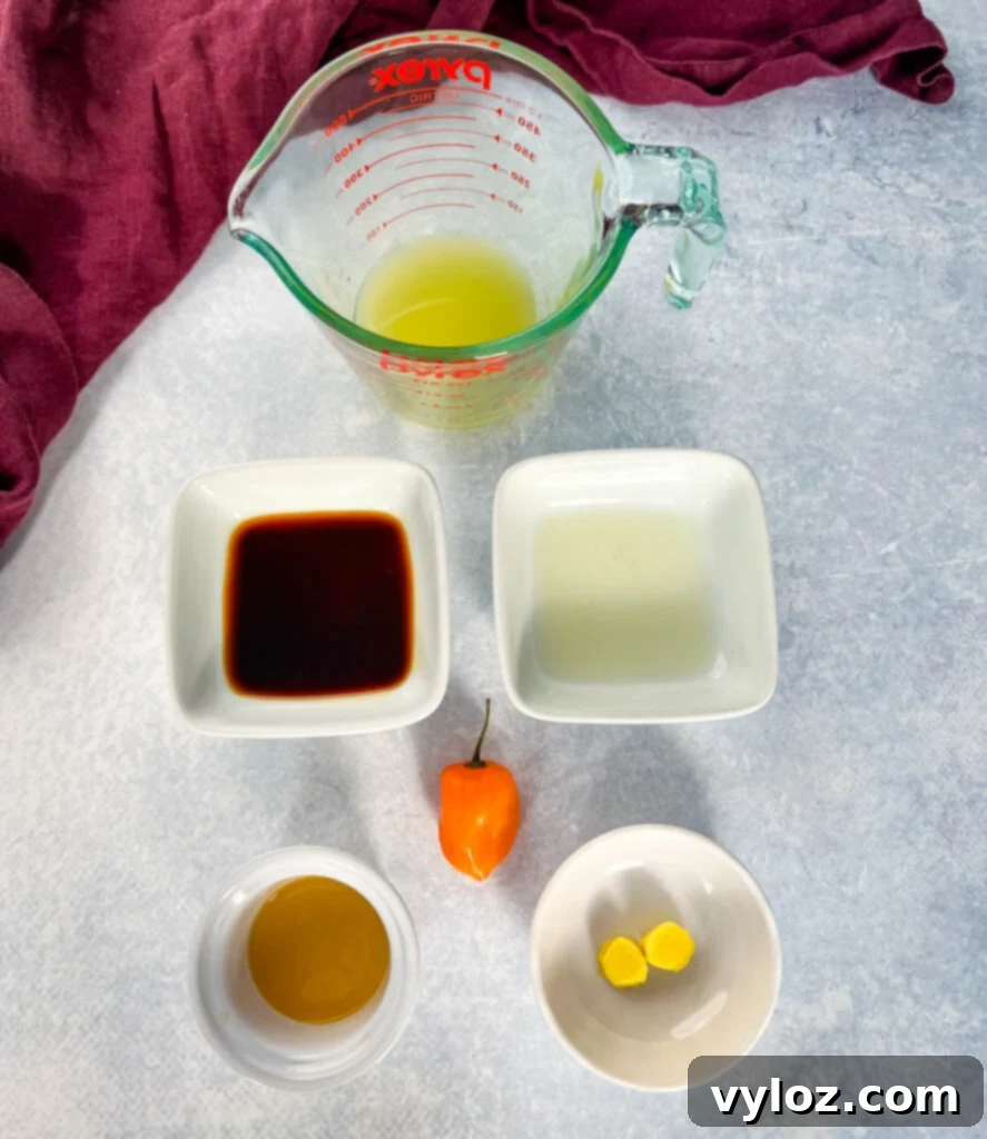 Bold Caribbean Jerk Marinade 4 Separate bowls containing pineapple juice, soy sauce, lime juice, liquid smoke, sliced habanero pepper, and fresh ginger, showcasing liquid ingredients for the marinade.