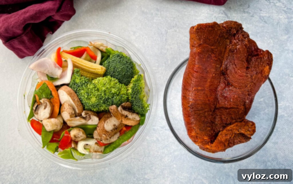 Sizzling Teriyaki Beef 3 Bowls of thinly sliced raw flank steak and a colorful assortment of fresh vegetables prepped for a teriyaki stir fry