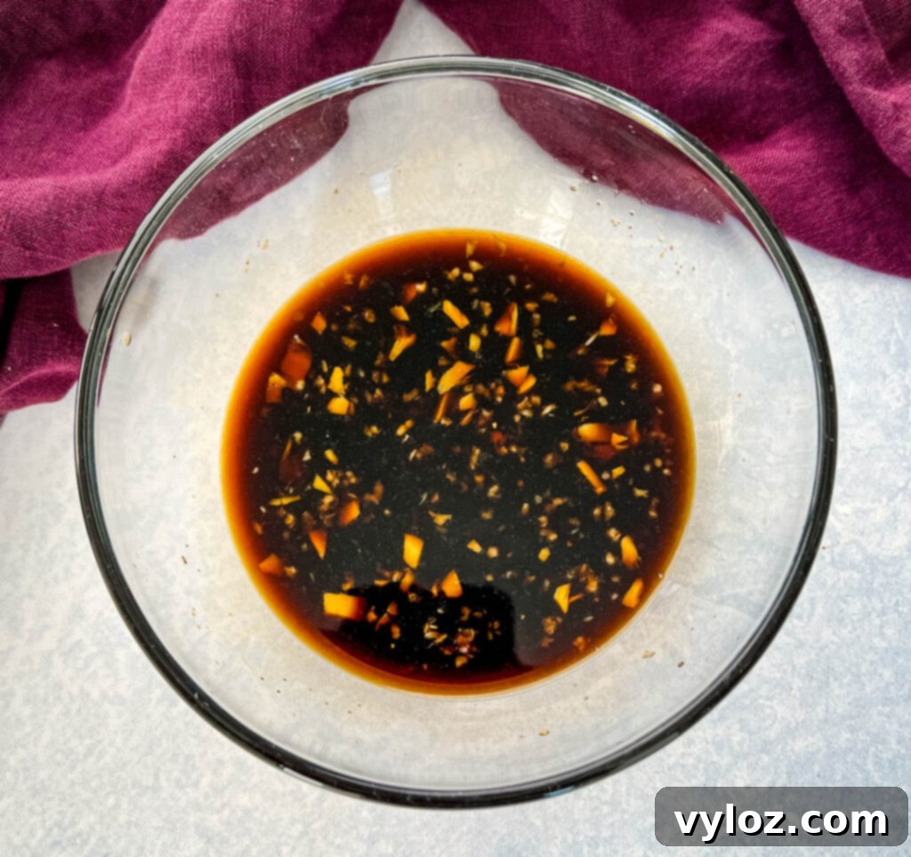 Sizzling Teriyaki Beef 4 Glass bowl containing a rich, homemade teriyaki marinade, ready for stir frying