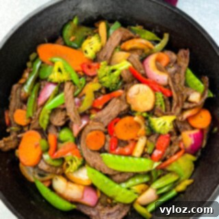 Sizzling Teriyaki Beef 8 steak stir fry in a cast iron skillet