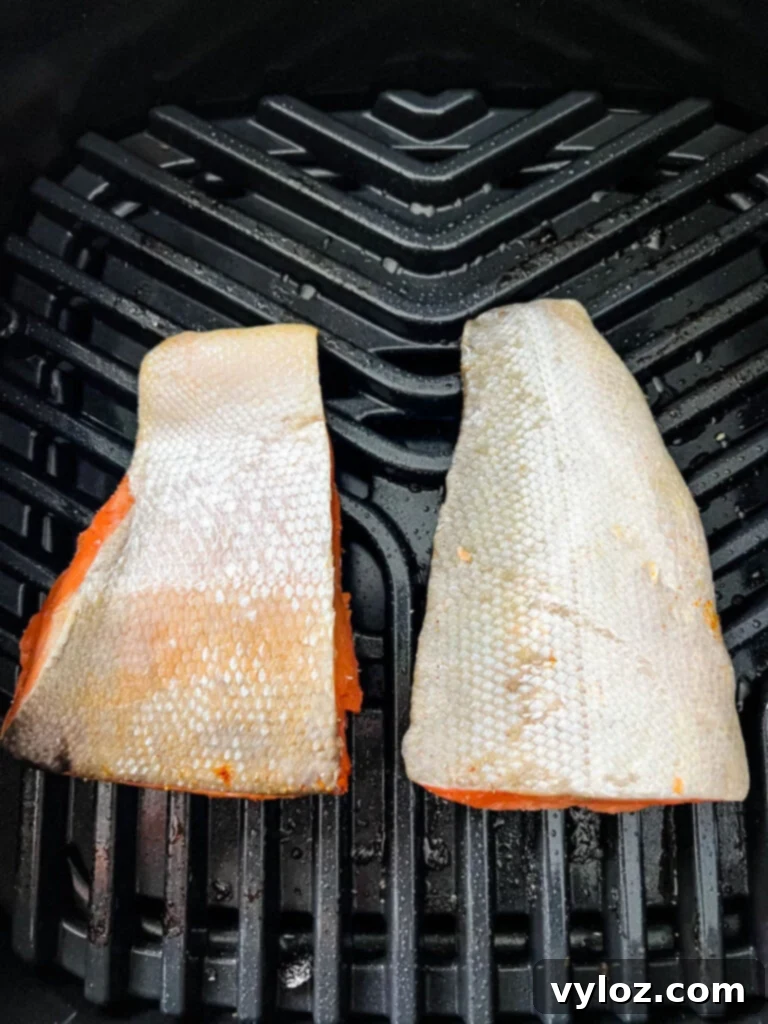 Ninja Foodi Grilled Salmon 5 Salmon cooking on an indoor grill, showing the grill marks forming.