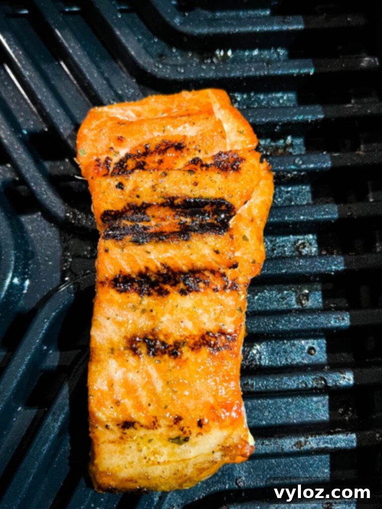Ninja Foodi Grilled Salmon 7 Close-up of salmon cooking on an indoor Cosori grill, showing the texture and color.