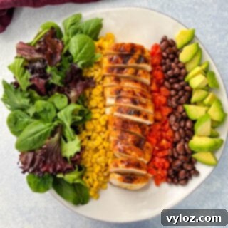 Smoky Southwest Salad with Chipotle Ranch 9 Southwest Salad with lettuce, corn, chicken, tomatoes, black beans, and avocado on a plate.