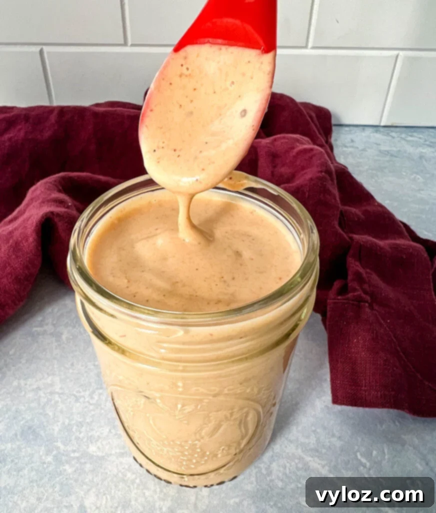 a spoonful of southwest salad dressing in a glass jar