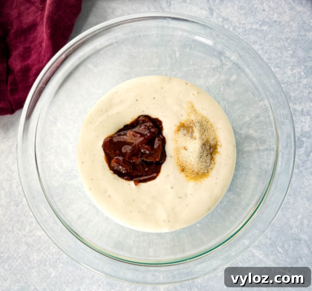 ranch, chipotles in adobo sauce, and spices in a glass bowl