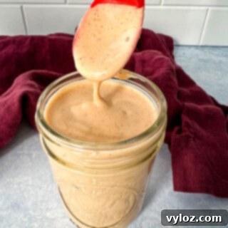 a spoonful of southwest salad dressing in a glass jar